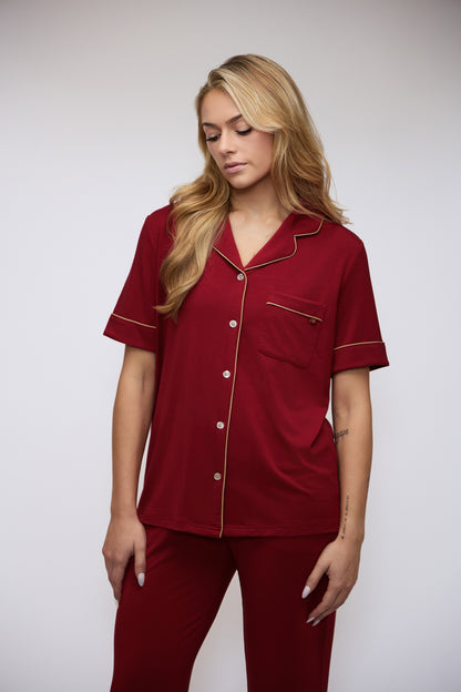 Model wearing the Moon & Mare Ember Set in wine, shown from the front with champagne piping and matching pants.